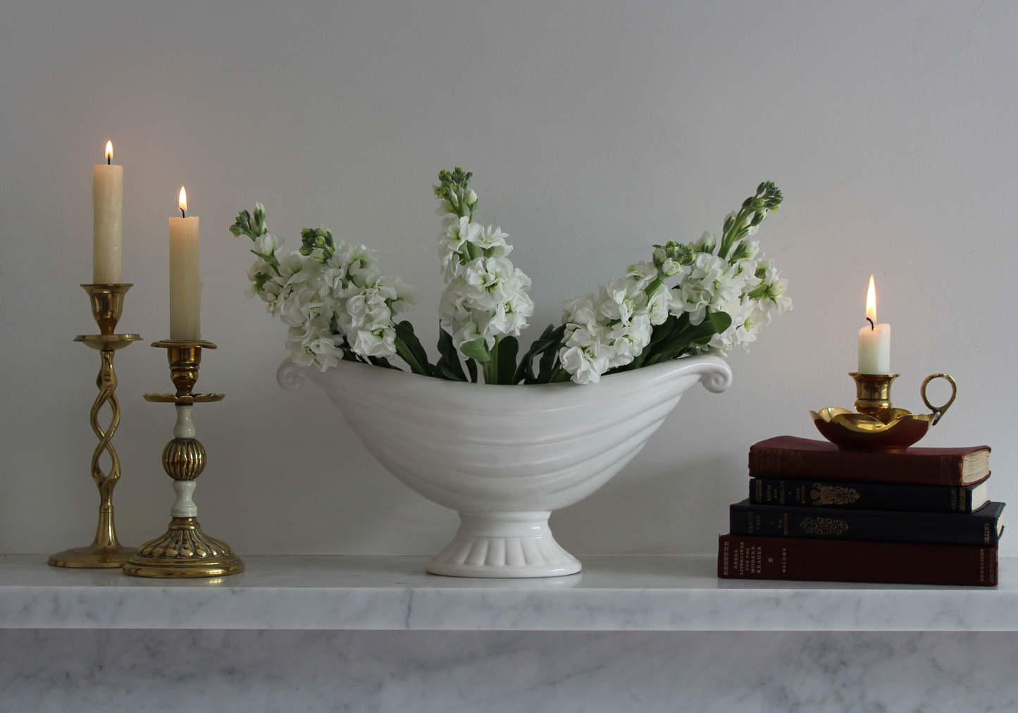 Marble mantlepiece with vintage candles, books and Price Bros mantle vase, c1930 (later Price and Kensington)