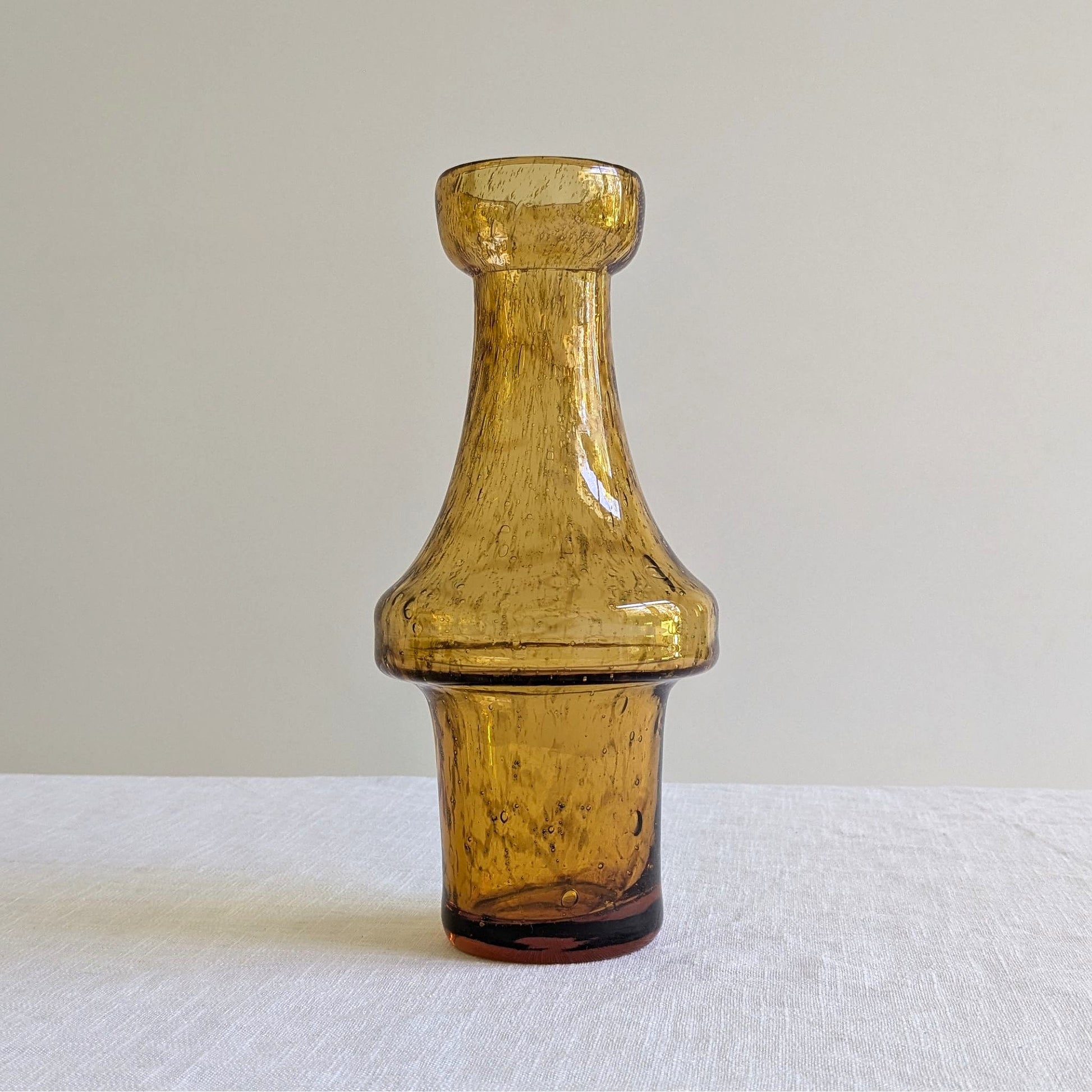 Amber glass vase on a white background