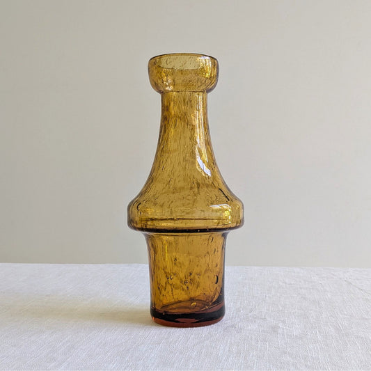 Amber glass vase on a white background