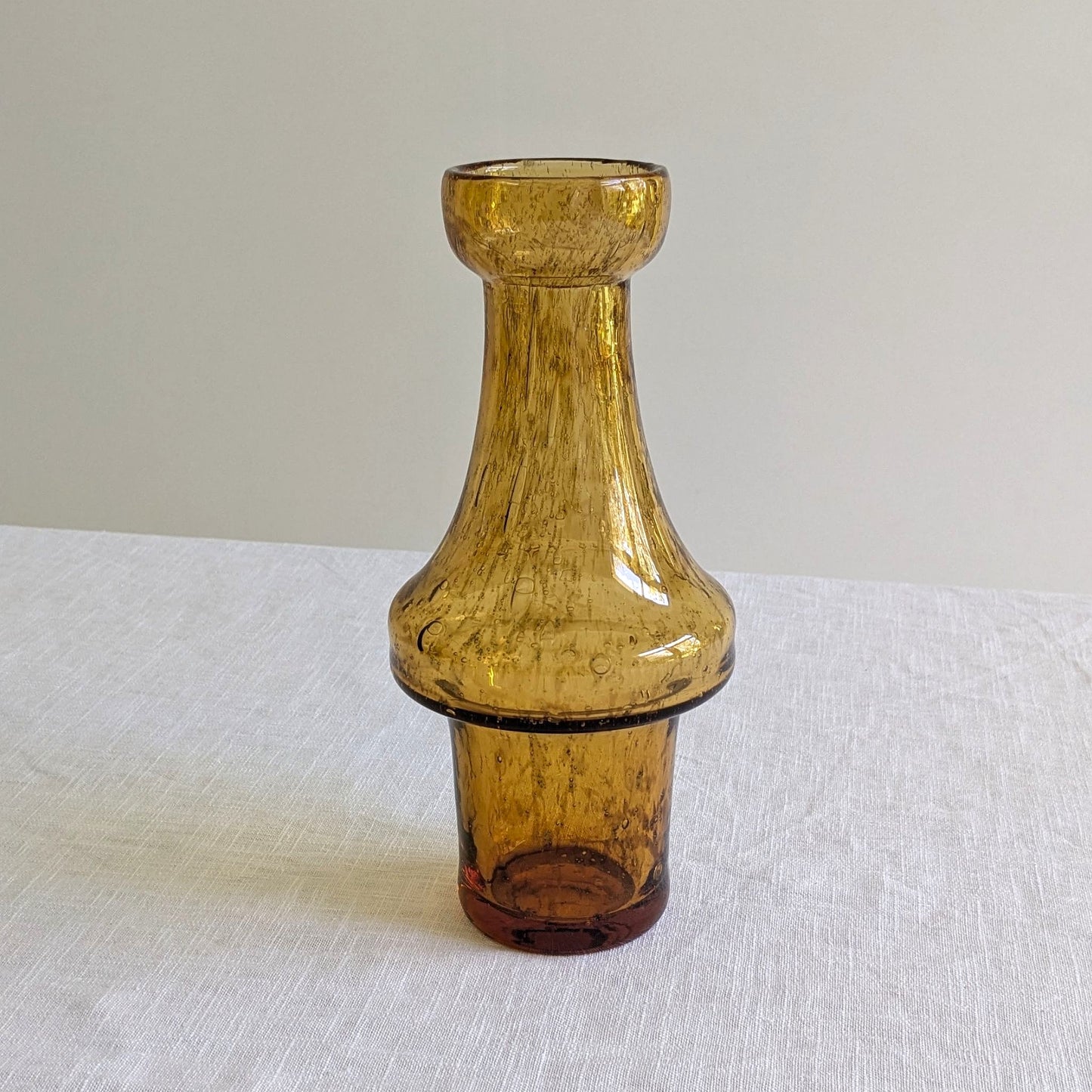 Amber colour glass vase on a white background