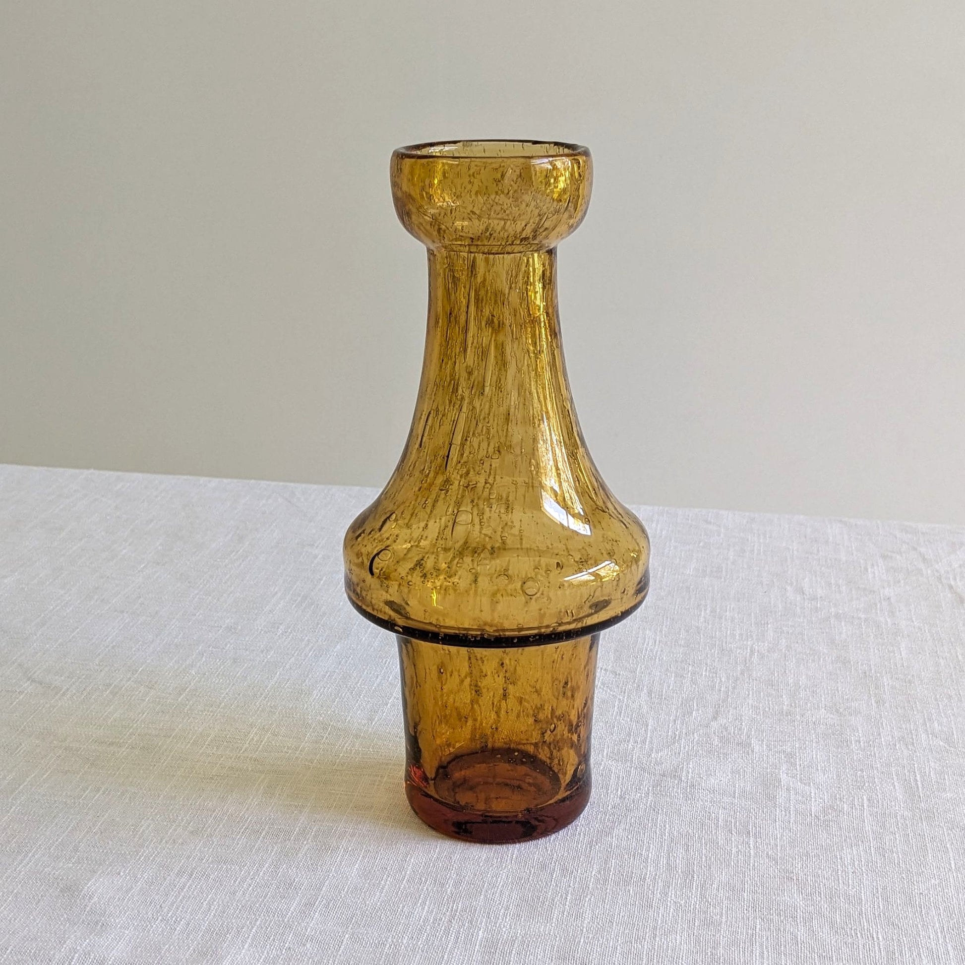 Amber colour glass vase on a white background