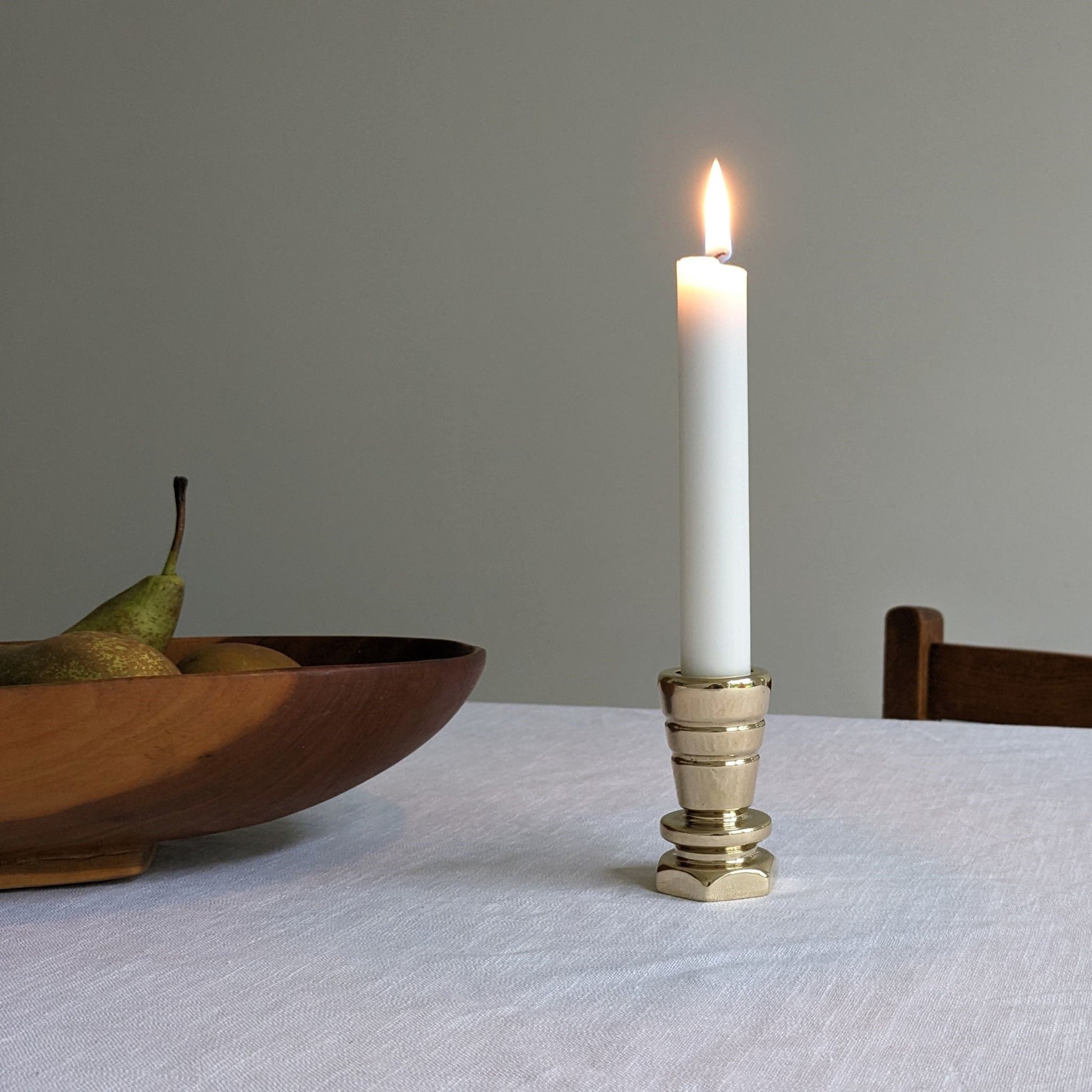 Brass candle holder with wooden fruit bowl
