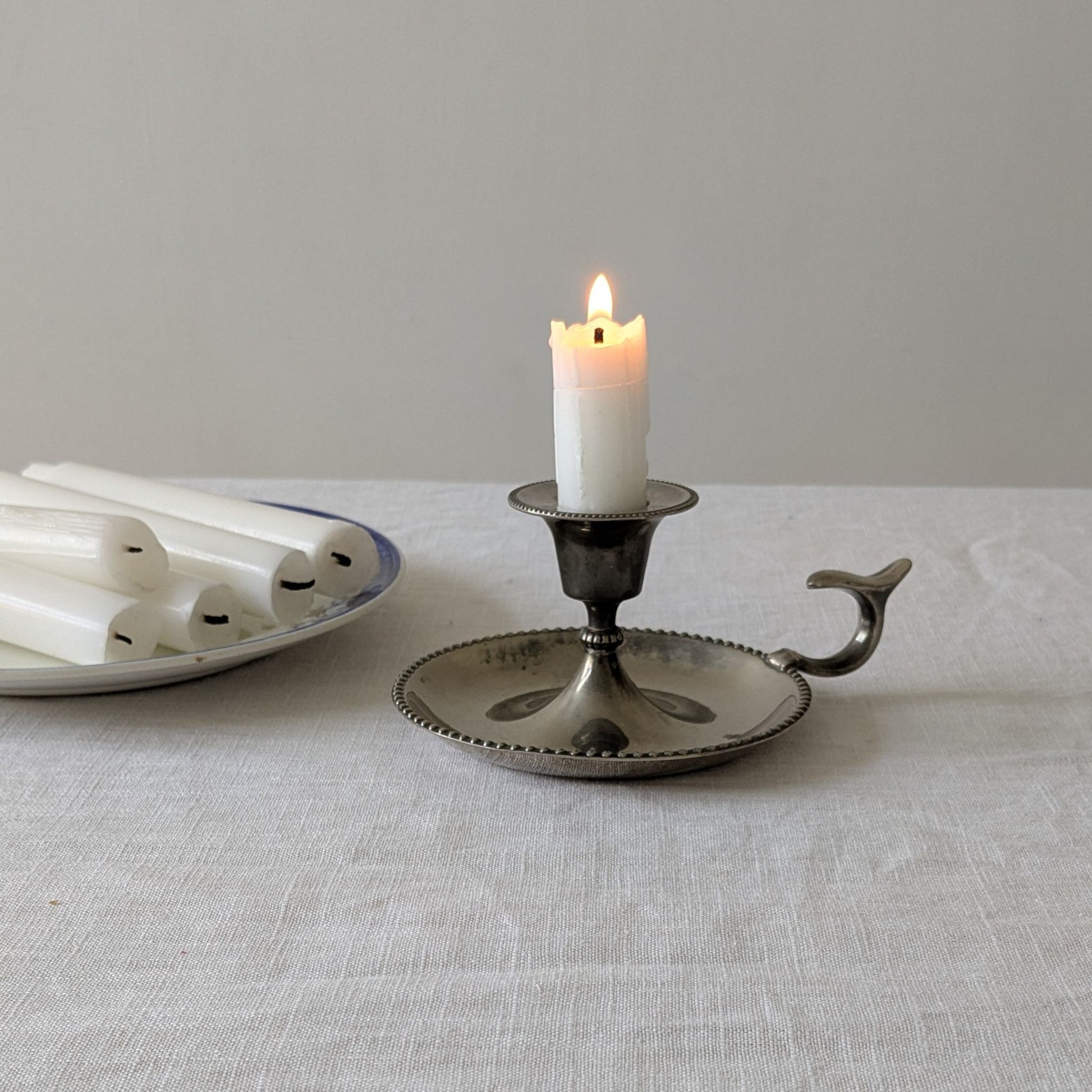 Vintage silver chamberstick with candle
